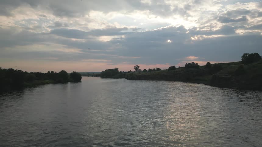 River with birds flying at dawn
