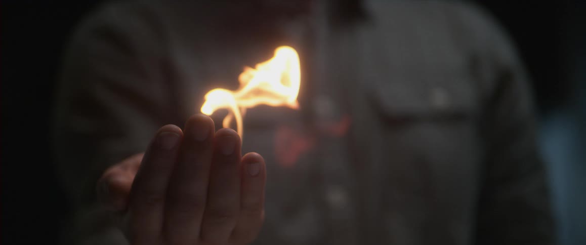 A person holding fire in their palm