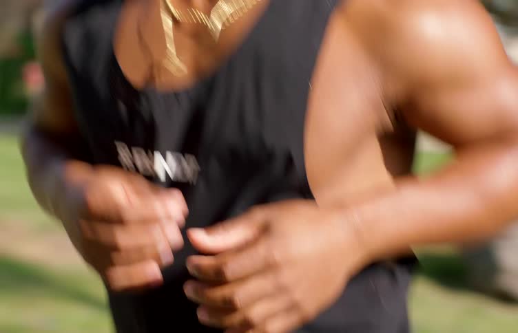 A person runs outside on the sidewalk