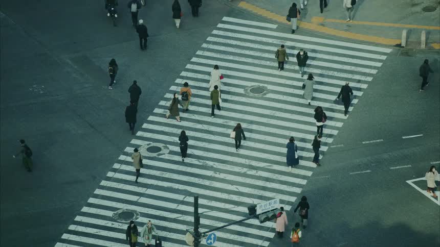 Pedestrians crossing an intersection in the city