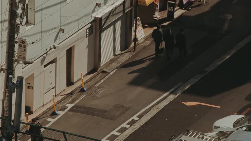 People walk on a street in a city during daytime