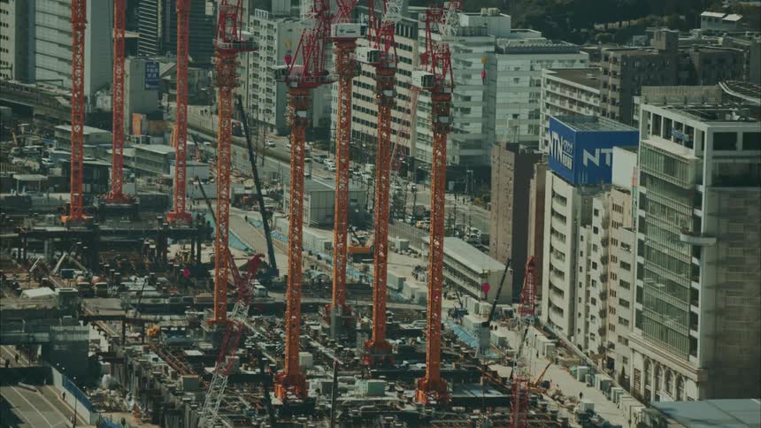 Panorama of construction cranes on the edge of modern buildings in a metropolis