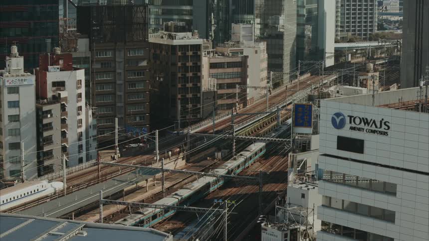 Trains drive along the tracks in a city