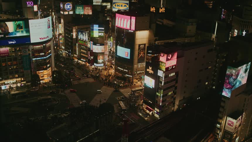 Crossroads of a metropolis at night with pedestrians and vehicle traffic
