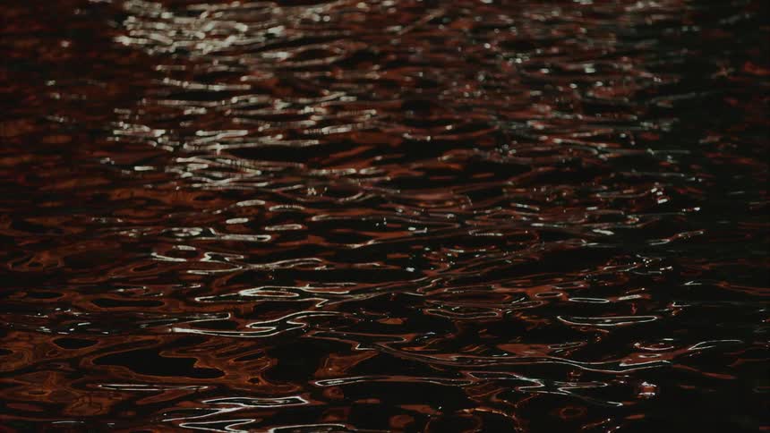 Calm waters of a sea with reflection of lights
