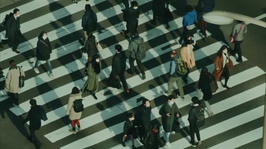 People crossing the pedestrian crossing at an intersection