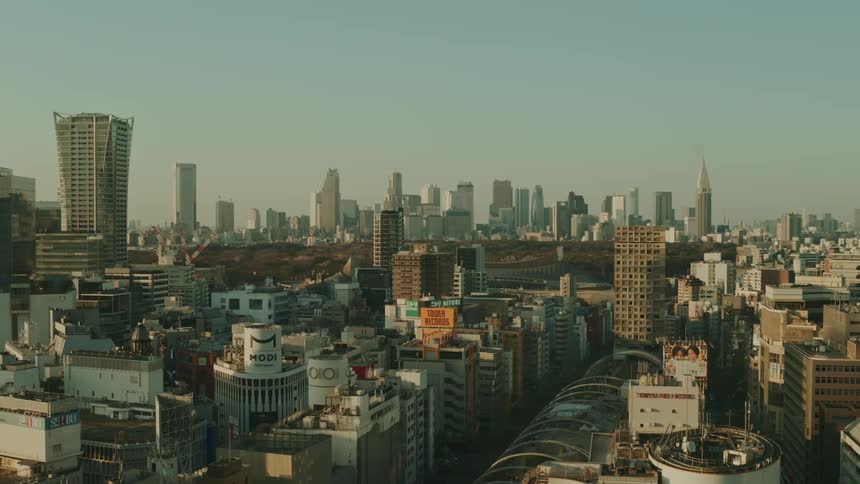 A sweeping slightly hazy aerial view of a densely packed cityscape