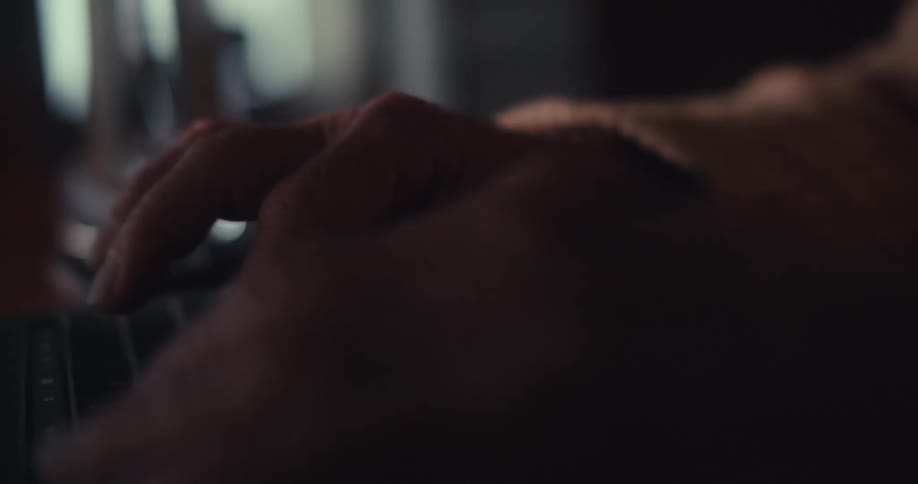 Elderly man typing on a laptop