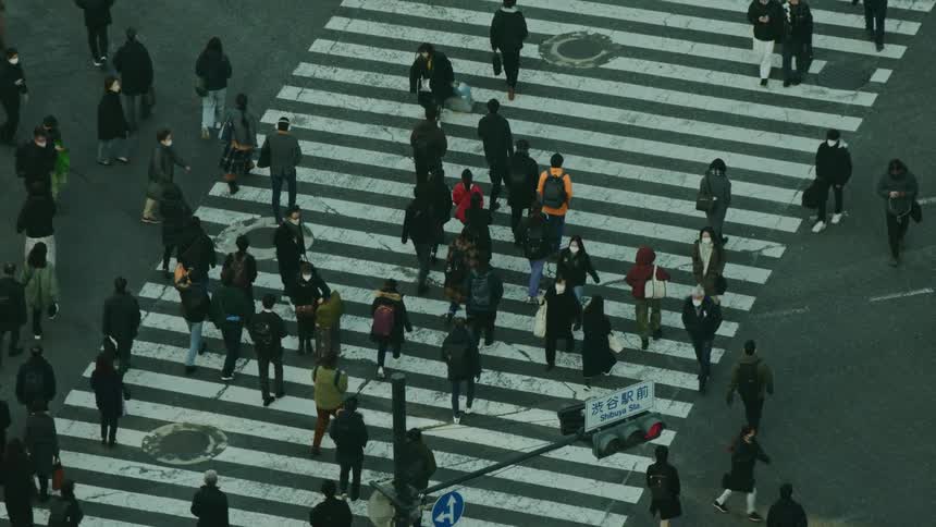 Crossroads in a metropolis with pedestrians crossing