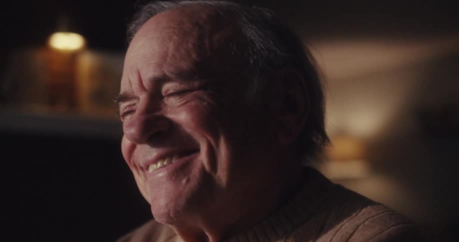 Elderly man in a room with a happy facial expression