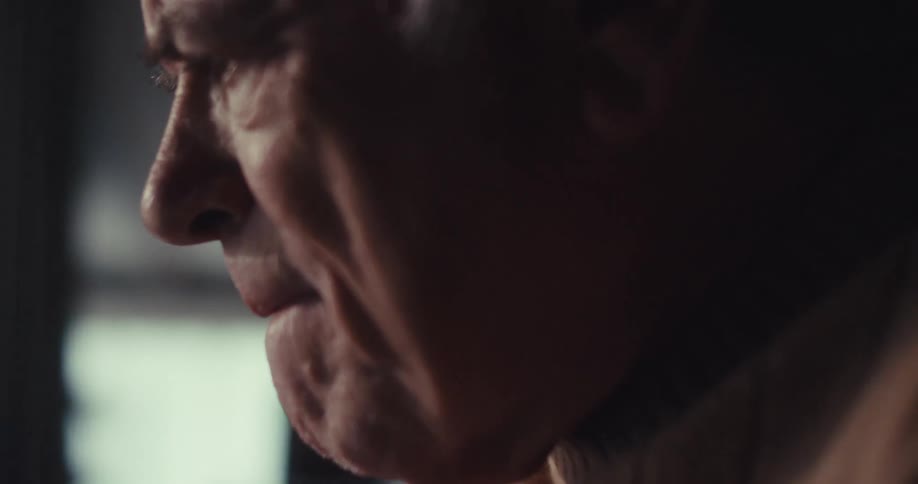 Elderly man sitting with a scared expression
