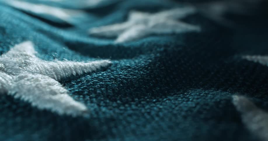 Close up of white stars embroidered on an american flag