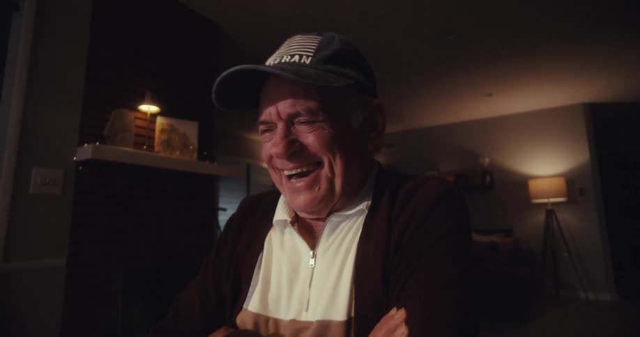 Old man in a cap laughing out loud