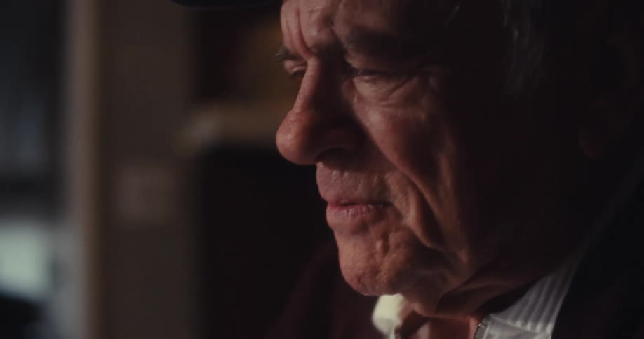 Old man typing on a laptop