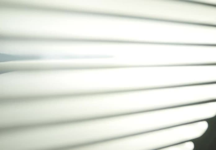 A closeup of horizontal neon lights flashing and blinking in an alternating pattern of bright and dark