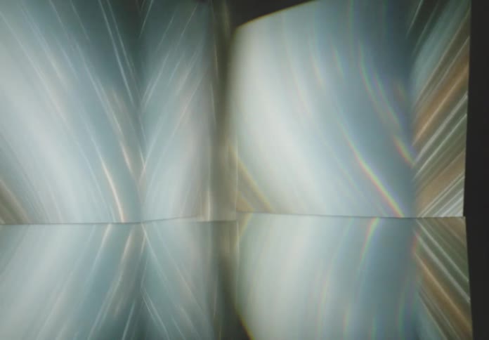 A mesmerizing display of light and reflections creates an abstract ethereal scene with soft flowing lines and gradients