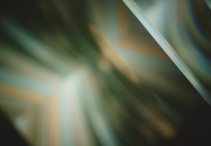 A mesmerizing display of light and reflections creates an abstract ethereal scene with soft flowing lines and gradients