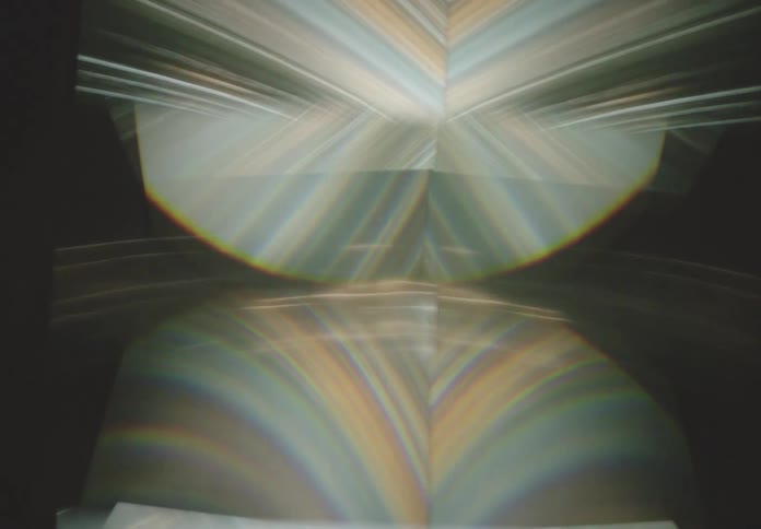 A mesmerizing display of light and reflections creates an abstract ethereal scene with soft flowing lines and gradients