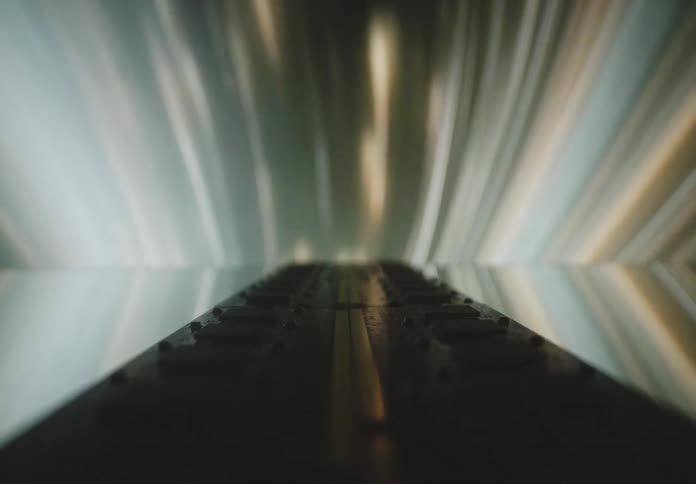 Platform floats toward an area filled with streaks of light