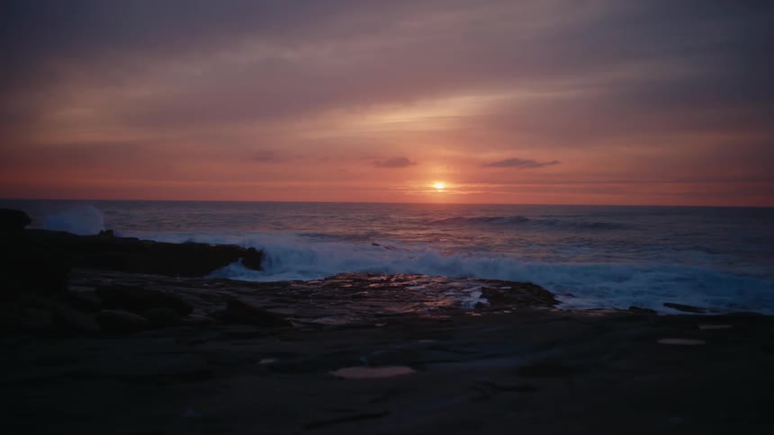 The sun is rising on the beach