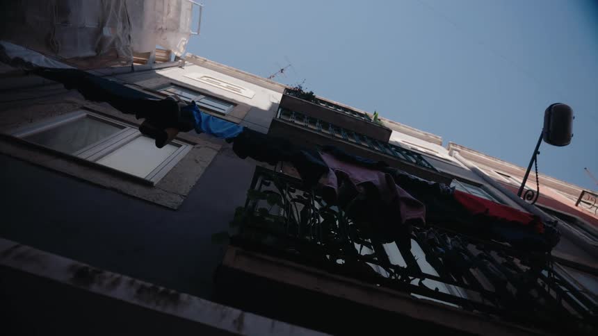 Building in a neighborhood with clothes hanging on a clothesline