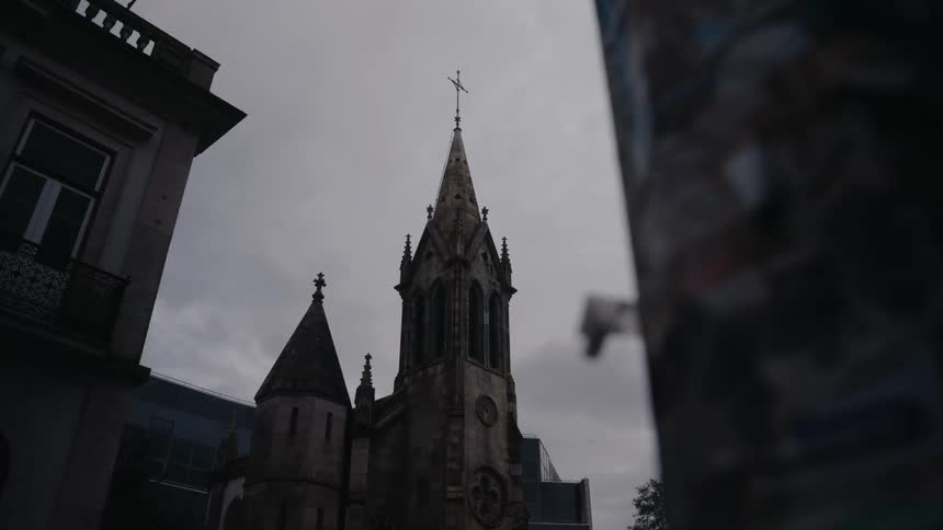 An old large catholic church under a cloudy sky