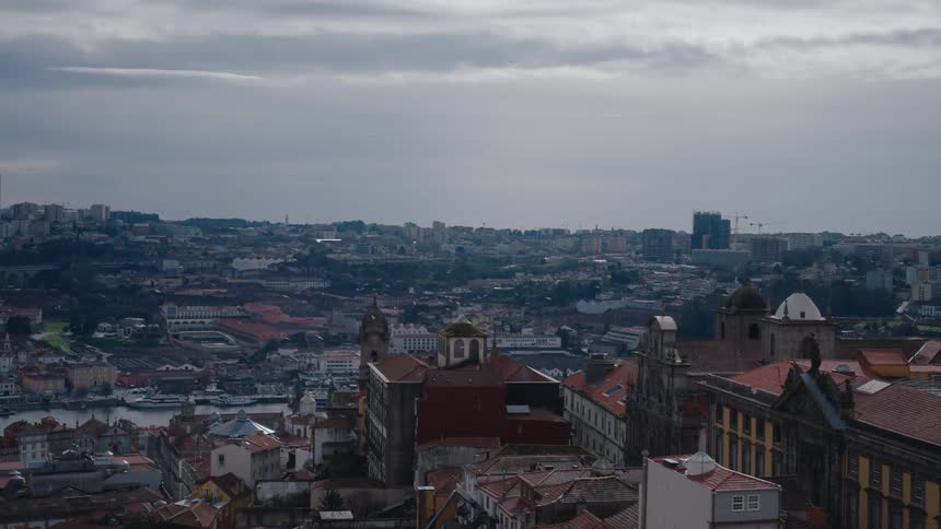 Flock of birds flies over apartment buildings and the nearby churches