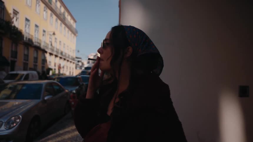 Woman with headscarf smoking