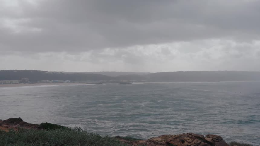 Heavy clouds and fog are on the shore line
