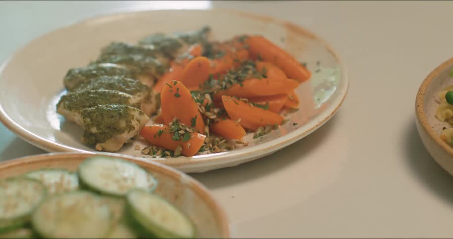 A meal and extra plates of vegetables are set out and ready to eat