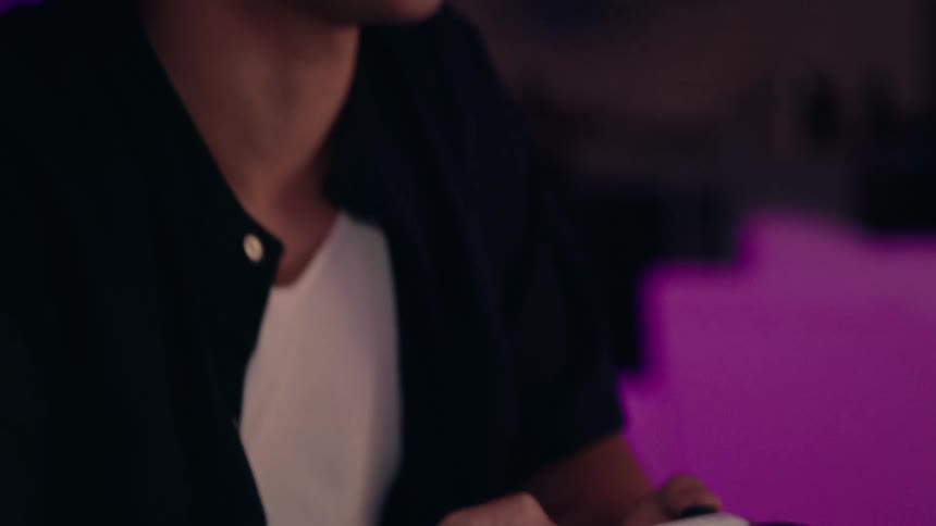 A man using a joystick to play a video game while talking and smiling