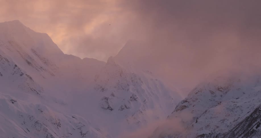 Snowcovered mountains and pink sky