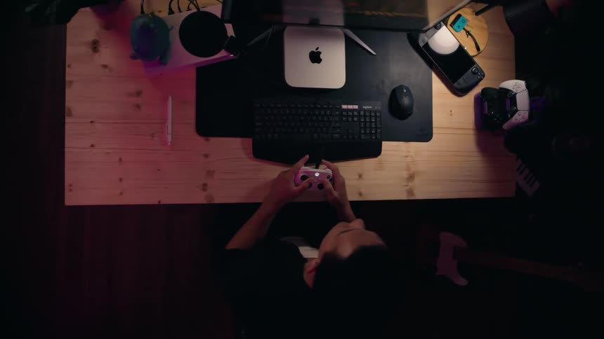 A man is playing video games at his desk