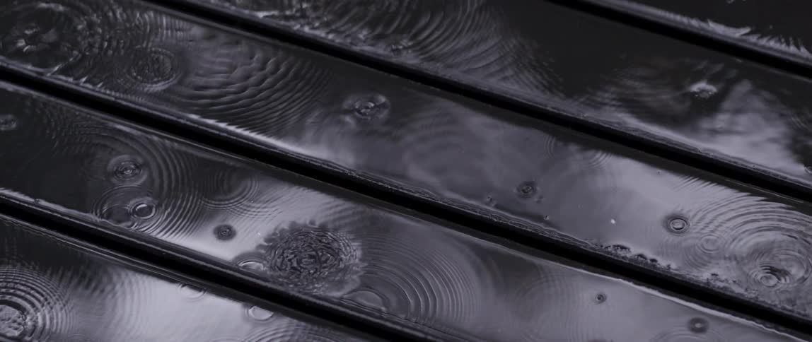 Rain is pouring on the wood boards