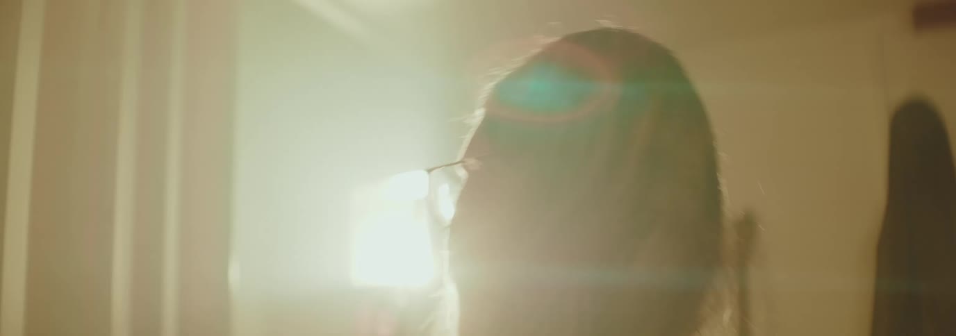 Blonde woman shaking her head while standing inside a room