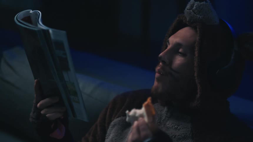 Sirens sudden flash on a man dressed as a bear that is eating a sandwich