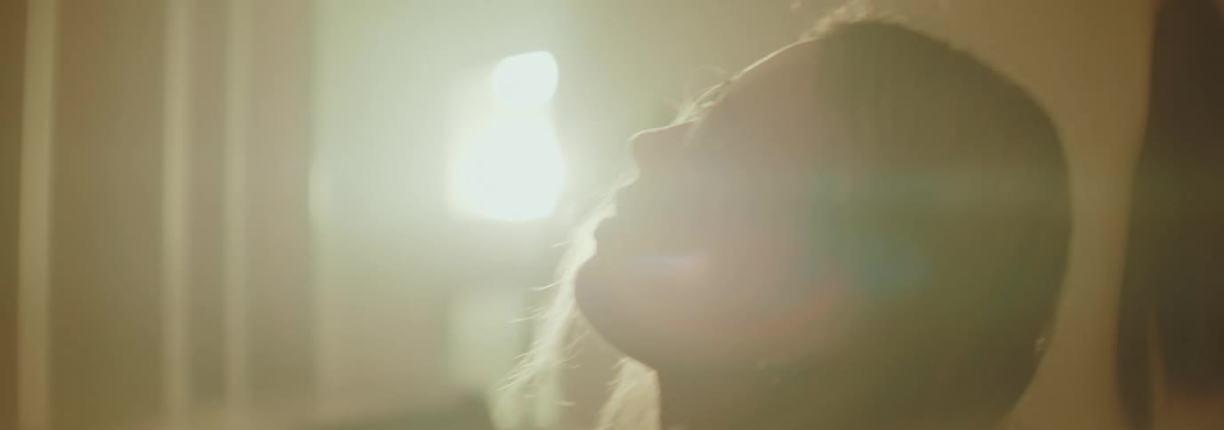Woman in an indoor space moving her head from side to side