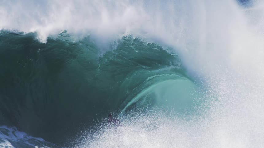 A man in the ocean surfing a big wave