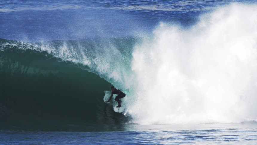 Surfer riding a strong tubular wave