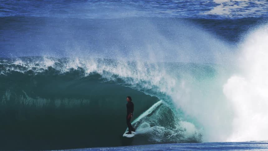 The man is surfing a huge wage