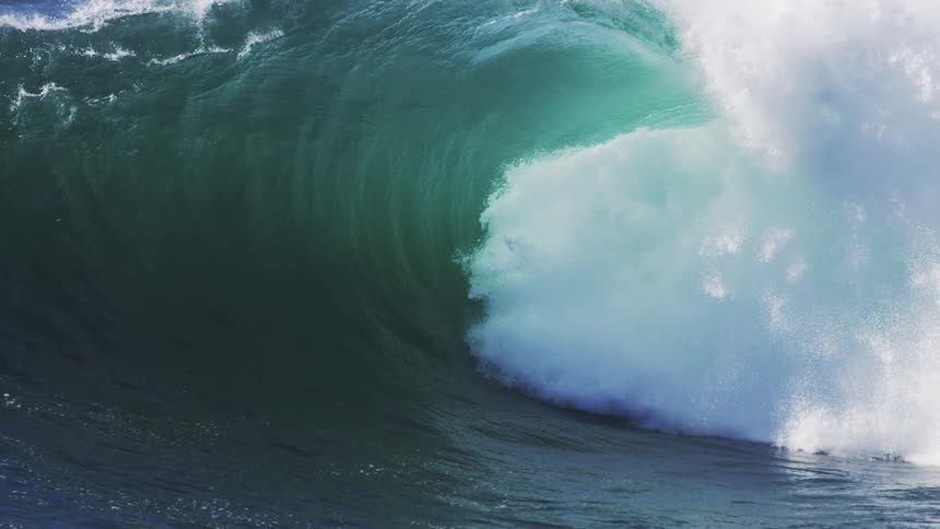 A huge wave crashing generating lots of spray and foam