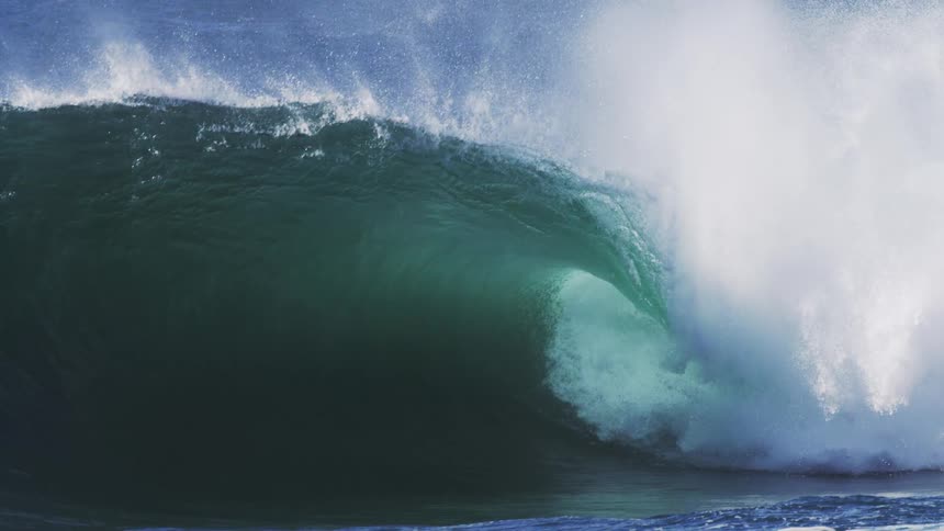 Forceful barrel wave crashing ocean in slow motion