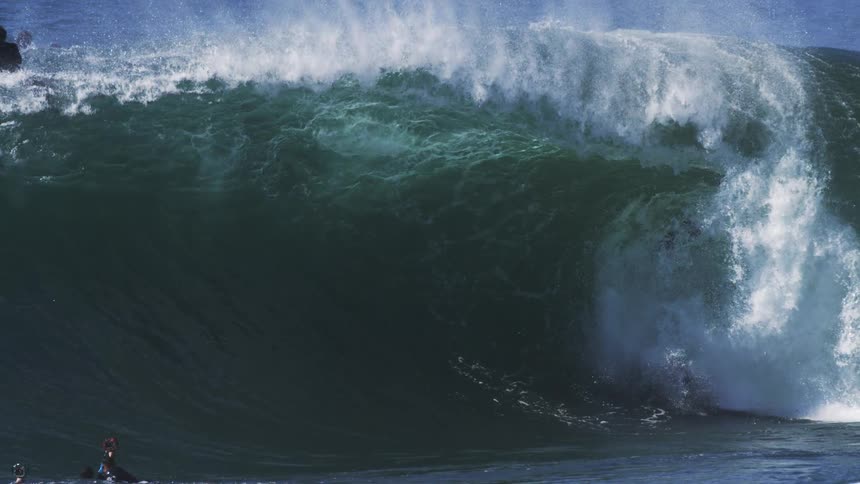 People and surfers in tubular waves in the ocean