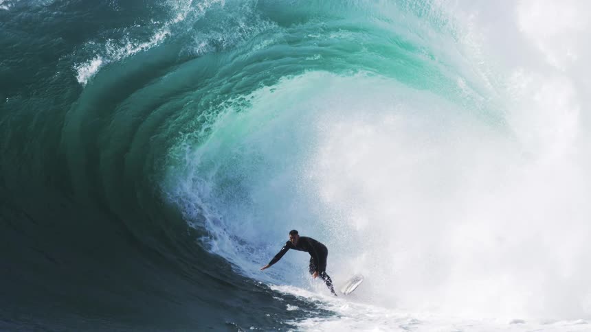 The surfer travels through the huge wage