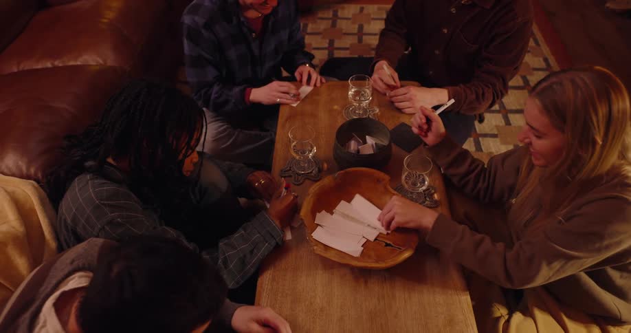 A group of friends play a game with small notes