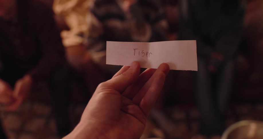 Hand holding a piece of paper with text