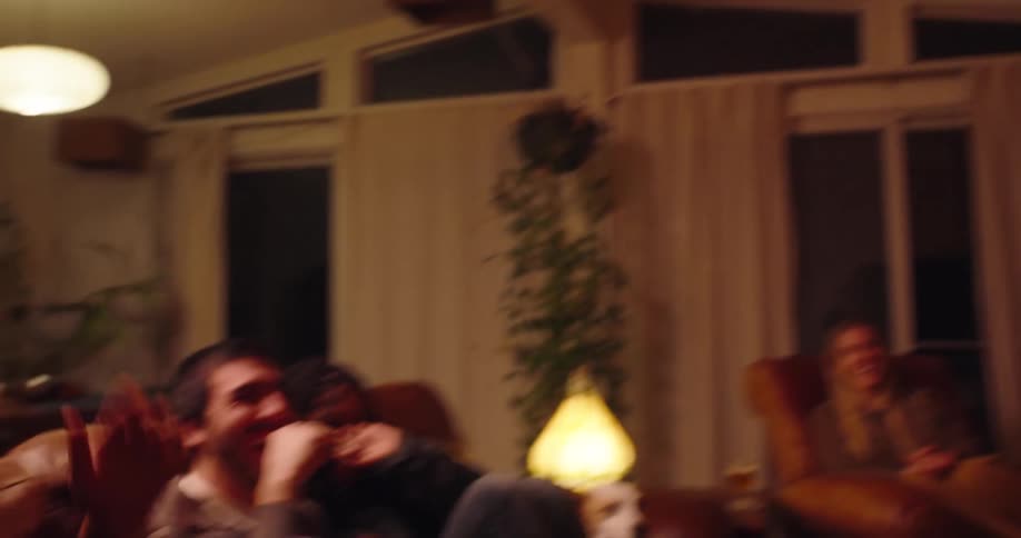 A group of friends joyfully celebrate and embrace indoors radiating warmth and emotional connection in a cozy living room setting