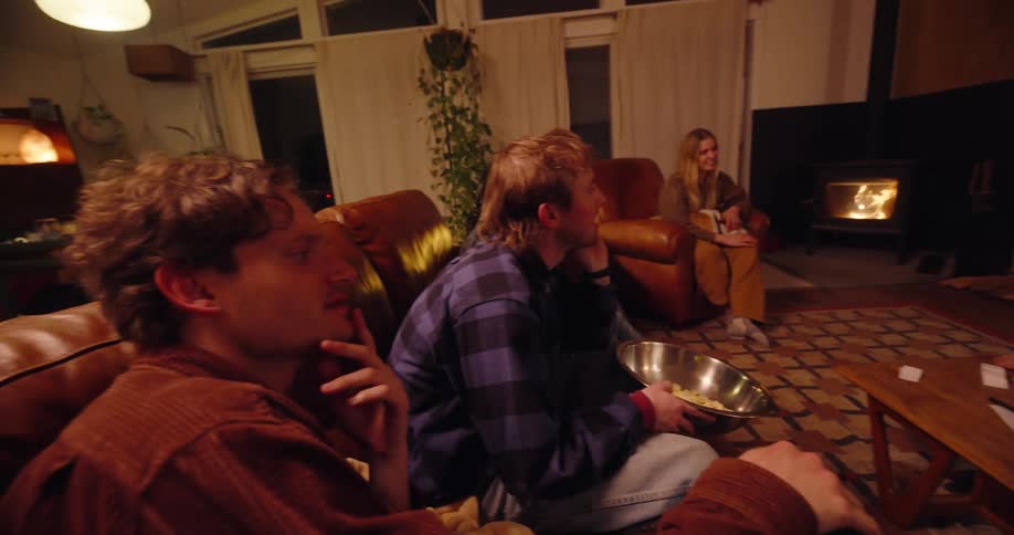A group of friends are playing charades in the living room