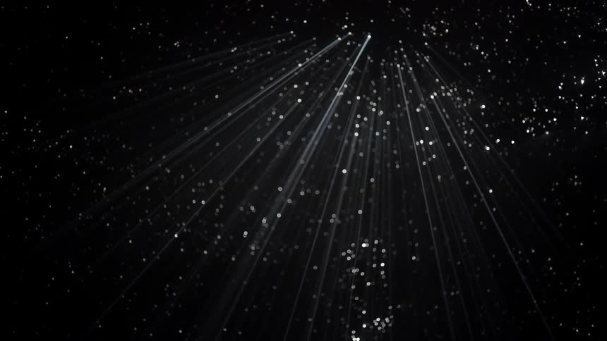 Beams of light poking through holes in a dark ceiling
