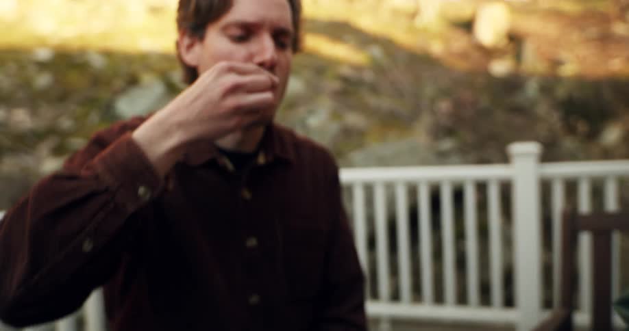 A group of friends is enjoying a casual outdoor gathering sharing snacks and engaging in friendly conversation